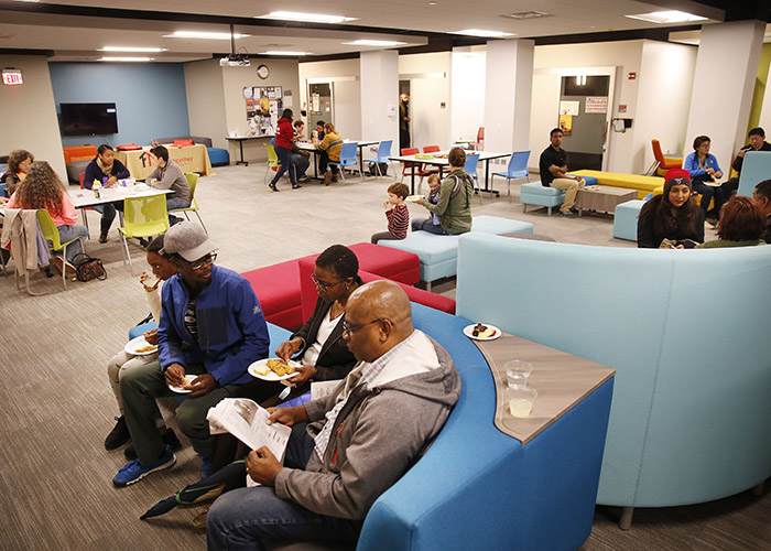 Groups of people eat and talk in the Center for Student Diversity and Inclusion